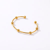 Bracelet manchette dorée à perles brillantes
