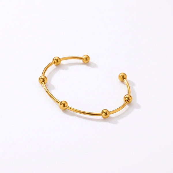 Bracelet manchette dorée à perles brillantes