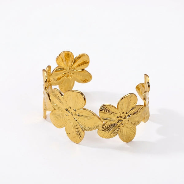 Bracelet manchette dorée fleurs en relief